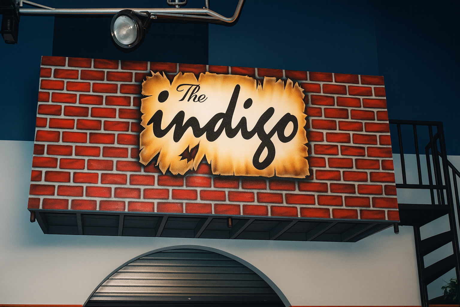 Brick wall with 'The Indigo' sign above a door